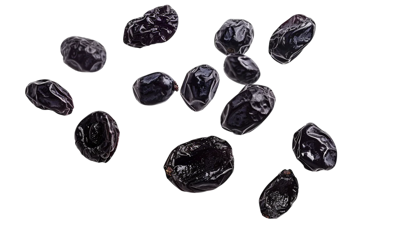 Scattered Dried Prunes on a Black Background Free PNG